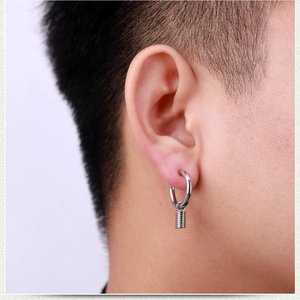 Close-up of men's silver stainless steel hoop earring with a spiral cylinder pendant