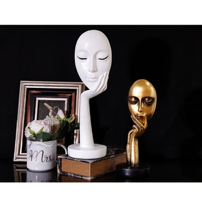 Artistic resin face sculptures in white and gold featuring a minimalist hand-to-face pose