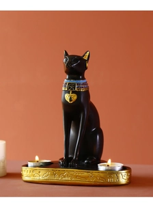 Detailed view of black Egyptian Bastet cat goddess resin candle holder with golden accents