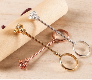 Detailed view of rose flower cigarette holder rings in gold, silver, and rose gold finish