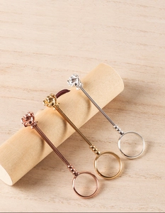 Detailed macro of rose-shaped cigarette rings in rose gold, gold, and silver finishes