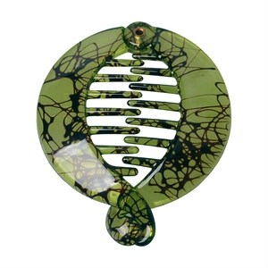 Detail view of green resin banana hair clip with black marble mesh texture and teeth