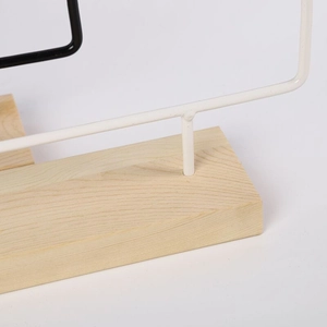Detail of the wrought iron jewelry rack with a natural pine wood base and metal frame