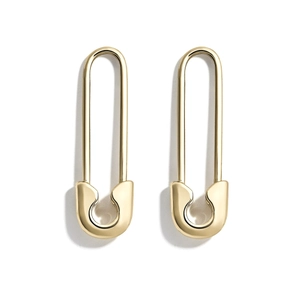 Pair of creative gold safety pin earrings with a polished metallic finish on white background