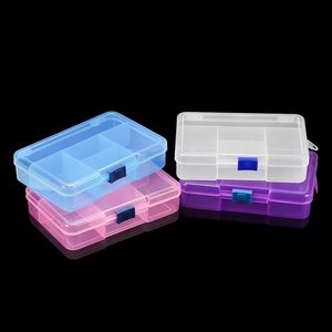 Stack of 5-grid transparent plastic storage boxes with colored buckles on black background