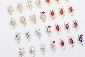 Detailed view of marquise cut nail art crystals in gold and silver metal settings