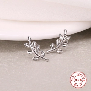 Macro detail of leaf-shaped S925 sterling silver earrings with polished finish