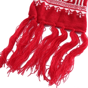 Thick red knitted scarf with white snowflake reindeer patterns and long fringe tassels