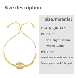 Detail of 18K gold-plated shell bracelet with micro-paved cubic zirconia and drawstrings