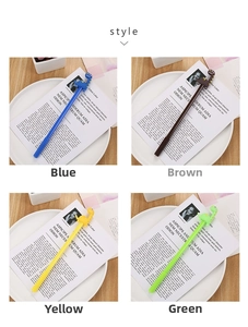 Close-up of cute cartoon long-necked dinosaur gel pens in blue brown yellow and green colors