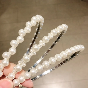 Three-piece set of handmade pearl headbands featuring elegant white beads on metal frames