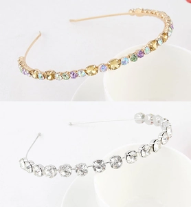 Detail showing gold and silver hairbands with colorful rhinestones and faux pearls