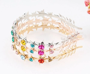 Close-up of star and leaf headbands with colorful rhinestones in gold and silver