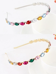 Detail of gold and silver alloy headbands with multi-colored oval rhinestones in claw setting