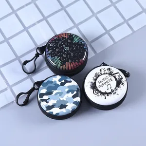 Round hardshell cases for earphones and coins featuring colorful music and camo designs