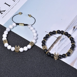 Close-up of crown bracelets with white marble turquoise, black beads and gold accents