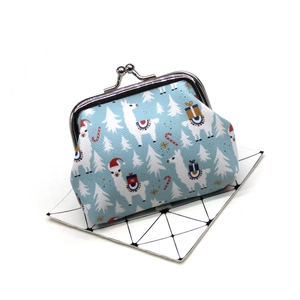 Detailed view of light blue Christmas alpaca coin purse with silver metal clasp closure