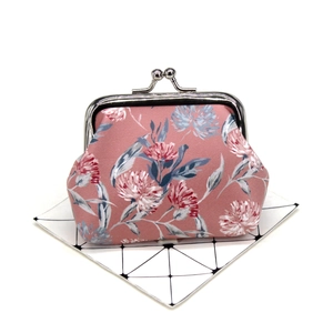 Detail view of vintage floral coin purse with metal clasp and elegant rose patterns