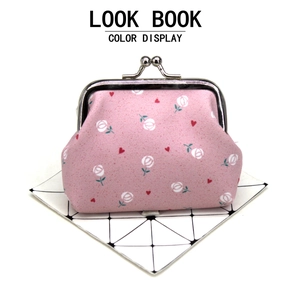 Detail view of pink floral coin purse with silver metal kiss-lock and rose heart pattern