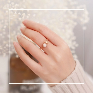 Detail of gold open ring with T-bar and micro-pave crystal ball on a finger