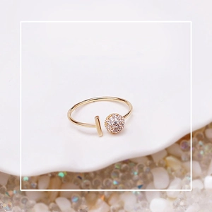 Close-up of gold-plated adjustable ring featuring a micro-paved zircon crystal ball detail