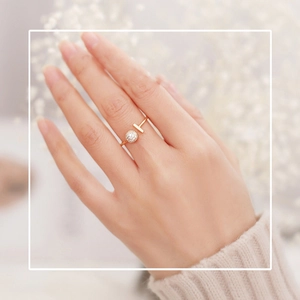 Detail of gold-plated open ring with T-bar and micro-paved crystal ball on finger