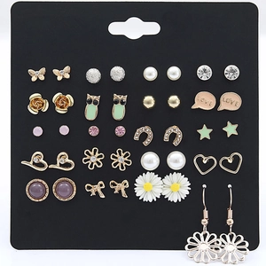 Detailed view of 20 pairs of minimalist assorted stud earrings on a display card