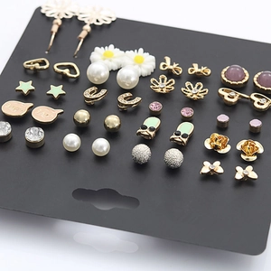 Close-up of 20-piece earring set featuring gold hearts, stars and pearls on display card