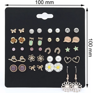 Detailed view of 20 pairs of assorted stud earrings including pearls and floral designs