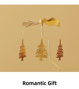 Golden rotating carousel candle holder with intricate laser-cut Christmas tree pendants
