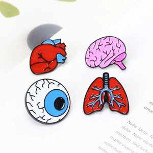 Macro shot of colorful enamel human organ brooch set featuring heart, brain, eye, and lung