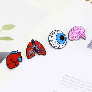 Detailed macro view of colorful enamel human organ brooches including heart and brain