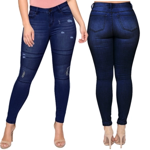 Detail of high waisted dark blue skinny jeans with distressed ripped holes and pockets