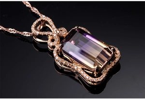 Close-up of rose gold necklace with rectangular gradient gemstone and diamond accents