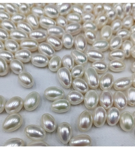 Detailed view of high-luster 7.5-8mm natural freshwater white teardrop pearls on fabric