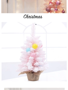 Close-up of pink mini Christmas tree with colorful ornaments and burlap base decoration