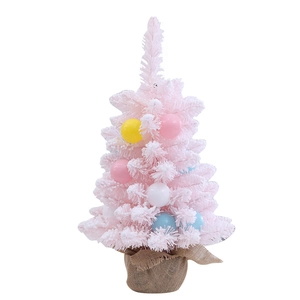Pink mini Christmas tree with colorful baubles and burlap base for festive tabletop decor