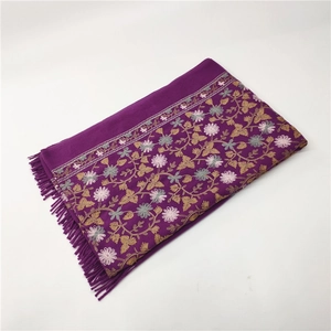 Detailed embroidery floral patterns and fringe tassels on a purple cashmere-like shawl