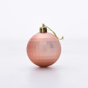 Detailed view of pink orange diamond faceted Christmas ball with gold cap and string
