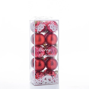 Detail of red Christmas balls with matte and glitter textures in a PVC gift box
