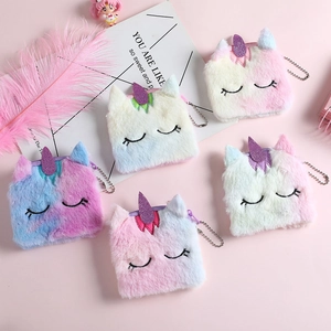 Detail of plush unicorn coin purses with gradient fur, zipper closure, and silver bead chains