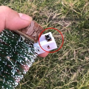 Close-up of the luminous switch and LED cable on Christmas tree ornament