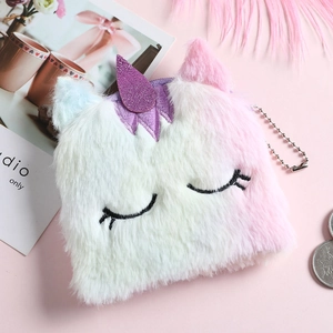 Detail of plush unicorn coin purse with purple glitter horn and embroidered eye design