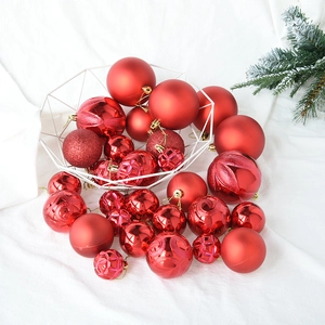 Macro shot of 30 red Christmas balls with matte and glitter finishes in a metal basket