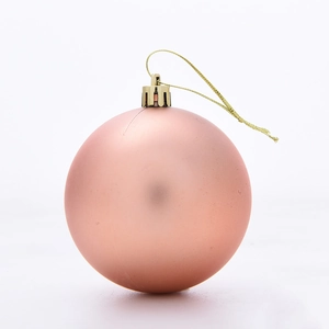 Detailed view of a matte rose gold Christmas ball ornament with a golden hanging string
