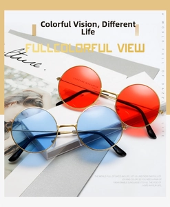Detail view of round vintage sunglasses with red and blue lenses in gold metal frames