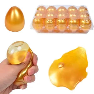 Golden egg-shaped squishy slime toy set with 12 pieces in a clear display tray