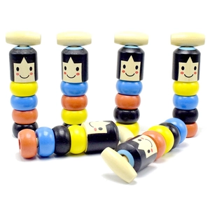 Detail of colorful wooden stacking toys with smiley faces and natural wood texture