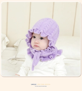Detail of baby winter knit hood with lilac ruffle edges and 3D cable stitch pattern