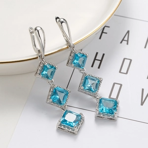 Elegant silver long drop earrings with four tiered blue gemstones for formal wear